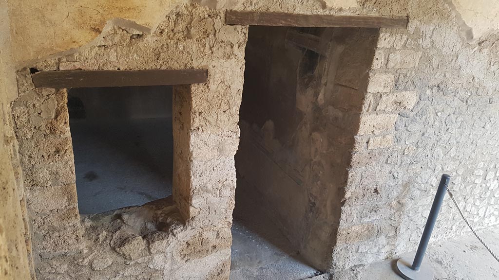 I.7.19 Pompeii. August 2023. 
Looking east to window and doorway to cubiculum in north-east corner of the pseudoperistyle. Photo courtesy of Maribel Velasco.