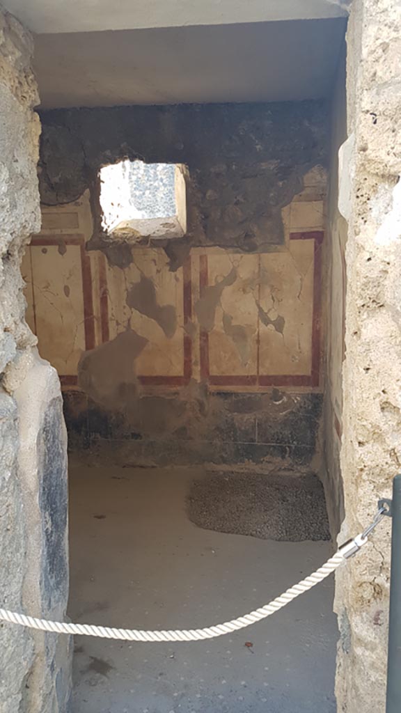 I.7.19 Pompeii. August 2023. 
Looking west through doorway into cubiculum in south-west corner of atrium.
Photo courtesy of Maribel Velasco.