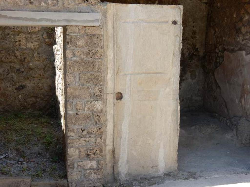 I.7.19 Pompeii. May 2017. 
Doorways to rooms in north-west corner of atrium, with plaster-cast of a door. Photo courtesy of Buzz Ferebee.