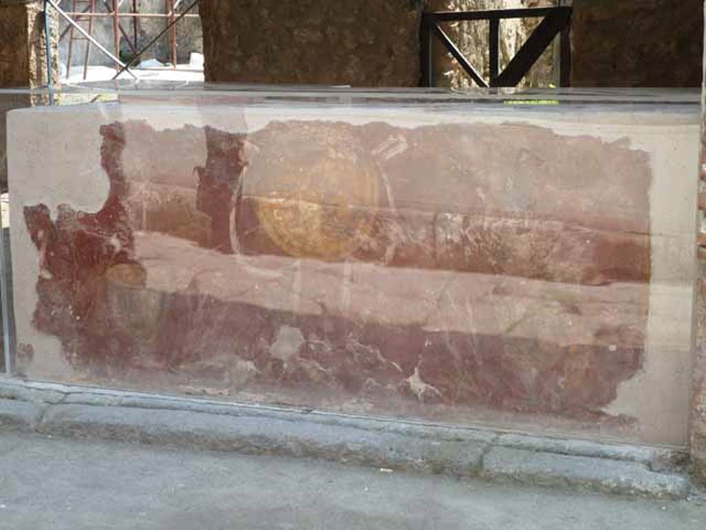 I.8.1 Pompeii. May 2010.  Counter, looking south. The shop counter shows a yellow shield or clypeus and Bacchus motifs on a red background.