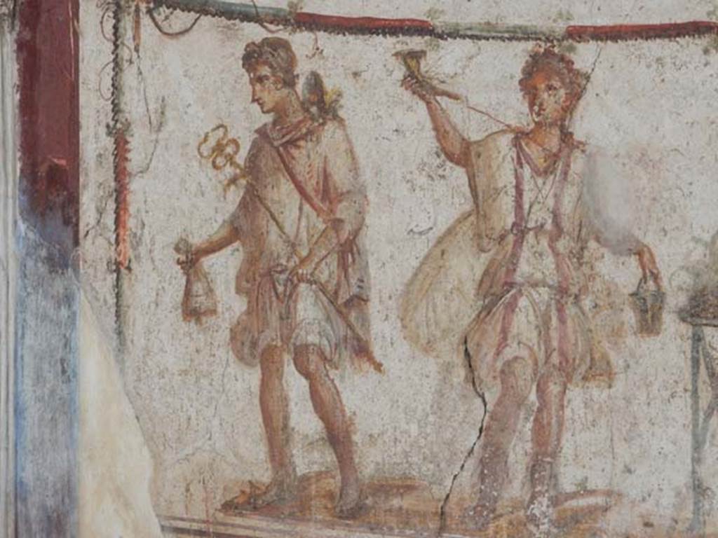 I.8.8 Pompeii. May 2015. Detail of painted figures on lararium, on the left is Mercury, and a Lar, on the right.  Photo courtesy of Buzz Ferebee.