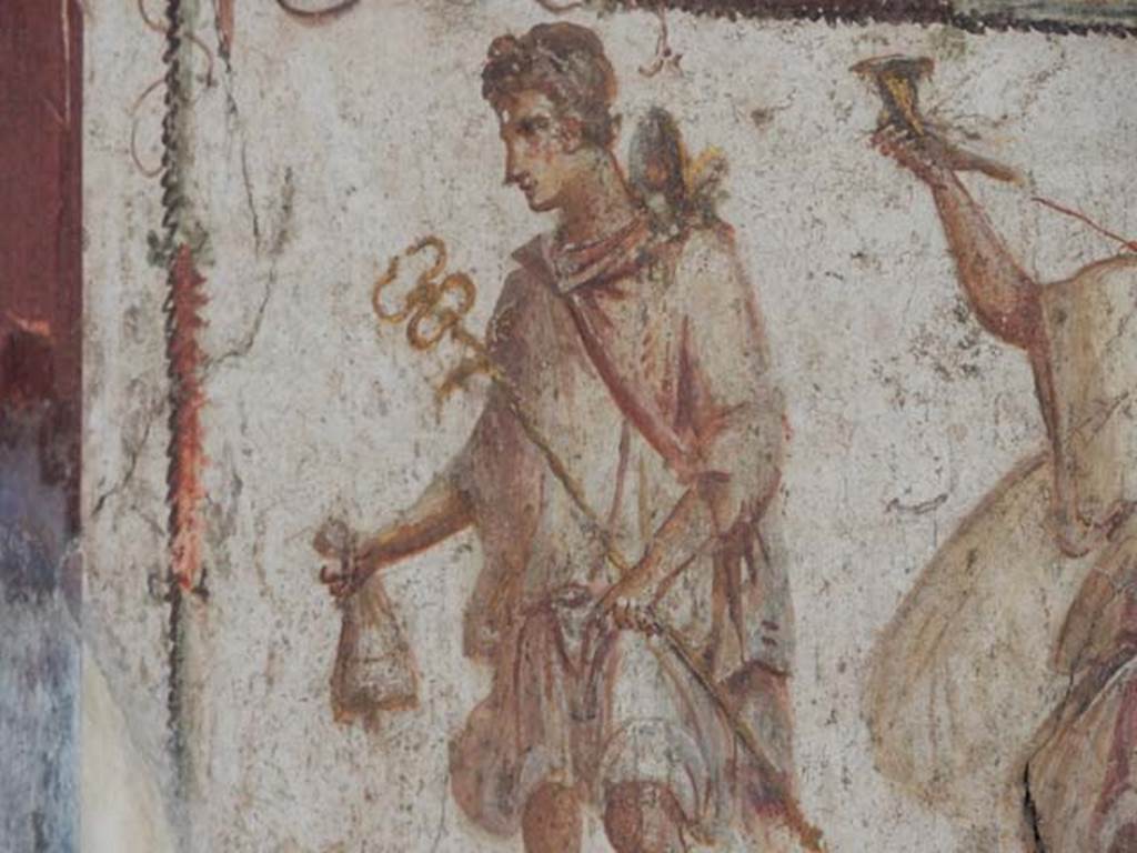 I.8.8 Pompeii. May 2015. Detail of painted figure of Mercury with his money bag.
Photo courtesy of Buzz Ferebee.