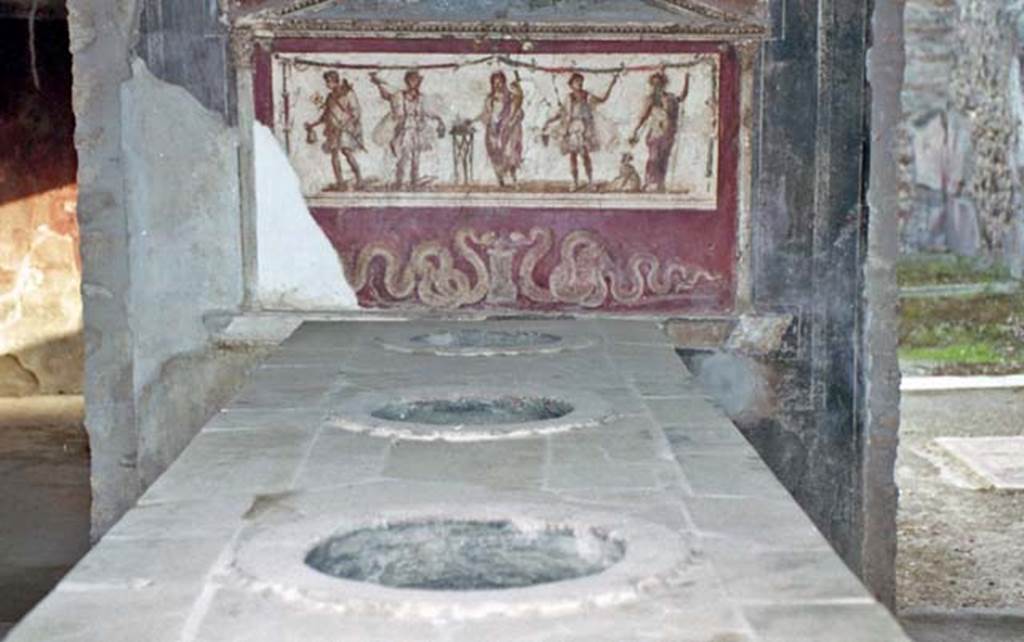 I.8.8 Pompeii. October 2001. Looking south along top of counter towards Lararium on south wall.  Photo courtesy of Peter Woods.