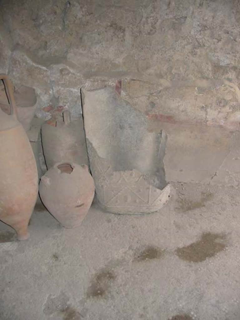 I.8.9 Pompeii. May 2003. Room 4, decorated lead bucket or puteal and terracotta items in room. 
Photo courtesy of Nicolas Monteix.