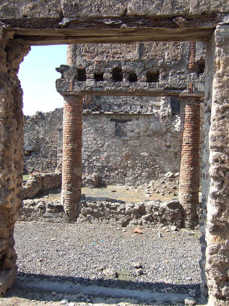 I.8.10 Pompeii. September 2005. Entrance. Looking west into peristyle area 1.
According to Jashemski, Della Corte identified the house as a caupona/hospitium and named it Hospitium dei Pulcinella.
One of two paintings on the façade showed Mercury with a group of men attired in costumes resembling those of the later Neapolitan Punch and Judy puppets.
The second shows men seated at tables on which are a variety of vases, possibly indicating a taberna vasaria selling vases.
See Della Corte, M., 1965. Case ed Abitanti di Pompei. Napoli: Fausto Fiorentino. (p.326).
See Jashemski, W. F., 1993. The Gardens of Pompeii, Volume II: Appendices. New York: Caratzas. (p.42)
See Morelli, V. C., L’insula 8 della Regio I: in Rivista di Studi Pompeiani, Vol. III, 1989, pp.185-221, and fig. 9.