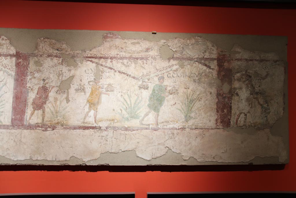 I.8.15 Pompeii. May 2024. Right hand part of centre part of painted panel with inscriptions. Photo courtesy of Klaus Heese.
On display in exhibition, entitled - “L’altra Pompei, vite comuni all’ombra del Vesuvio”.