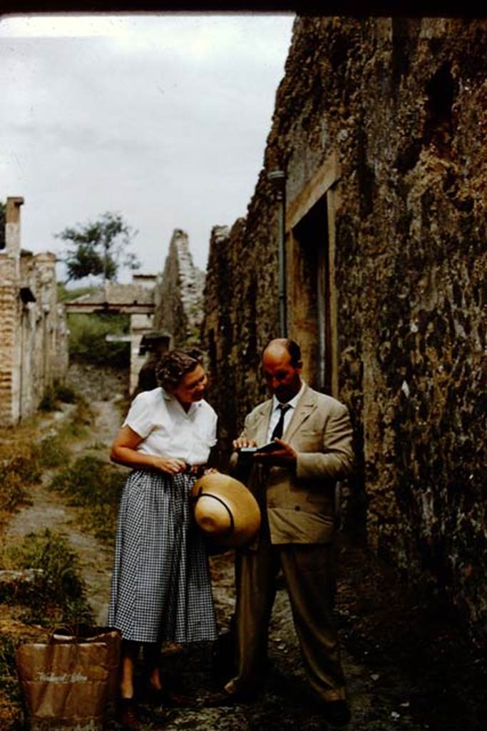 I.8.19 Pompeii. 1959. Wilhelmina and colleague outside entrance.
Vicolo dell’Efebo, looking north towards Via dell’Abbondanza. 
Photo by Stanley A. Jashemski.
Source: The Wilhelmina and Stanley A. Jashemski archive in the University of Maryland Library, Special Collections (See collection page) and made available under the Creative Commons Attribution-Non-Commercial License v.4. See Licence and use details.
J59f0494