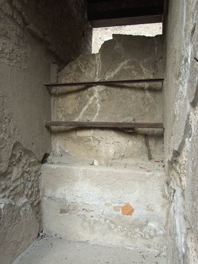 I.9.1 Pompeii. March 2009. Rear of plaster cast of entrance door in fauces.
According to PPM, the floor was of lavapesto which had a “carpet” design of white tesserae and coloured marble tiles scattered within a row of white tesserae.