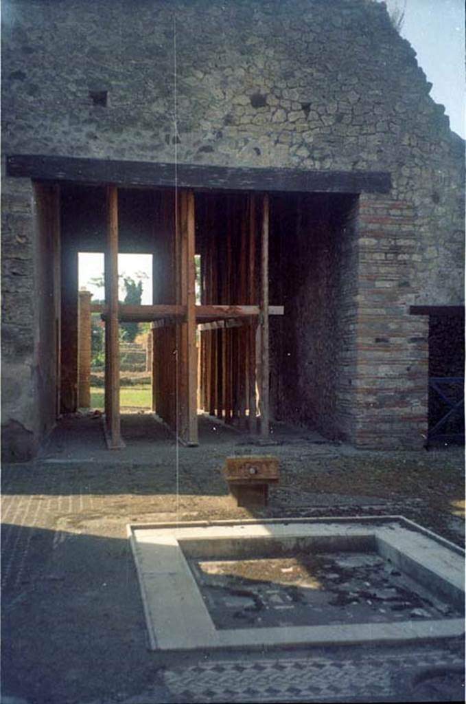 I.9.1 Pompeii. July 2011. Room 2, atrium. Looking south across impluvium towards tablinum.
Photo courtesy of Rick Bauer.