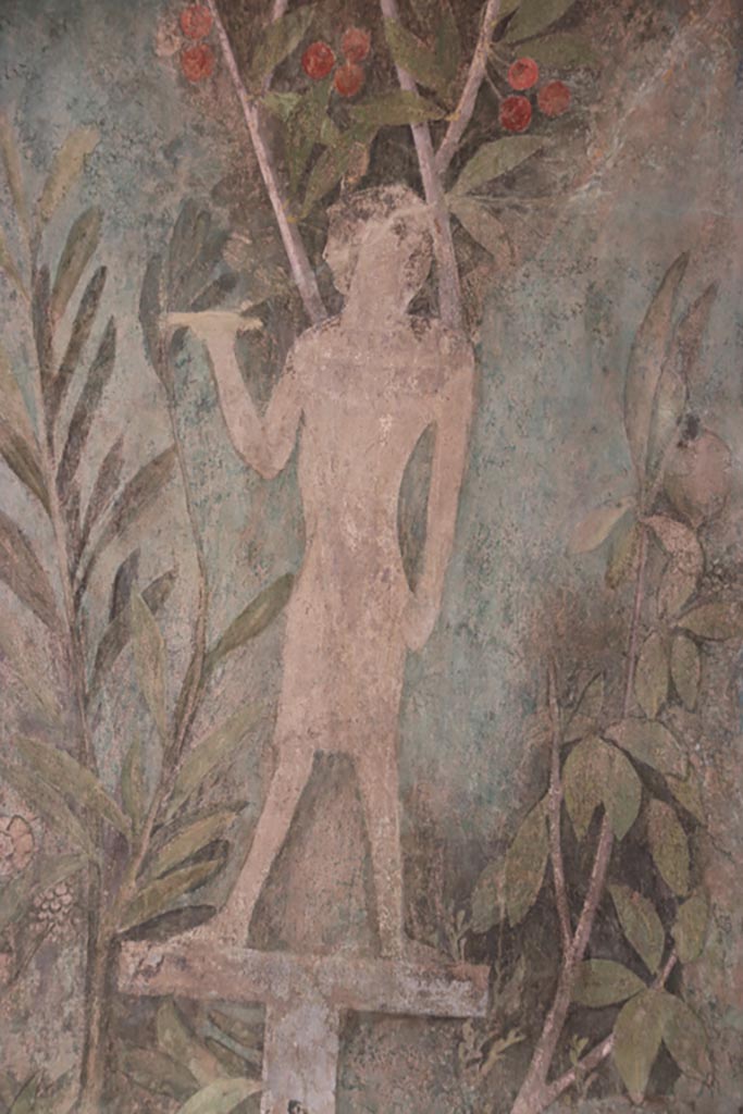 I.9.5 Pompeii. October 2022. 
Room 5, detail of painting of Egyptian pharaonic statue and cherry tree from south end of east wall of cubiculum.
Photo courtesy of Klaus Heese.