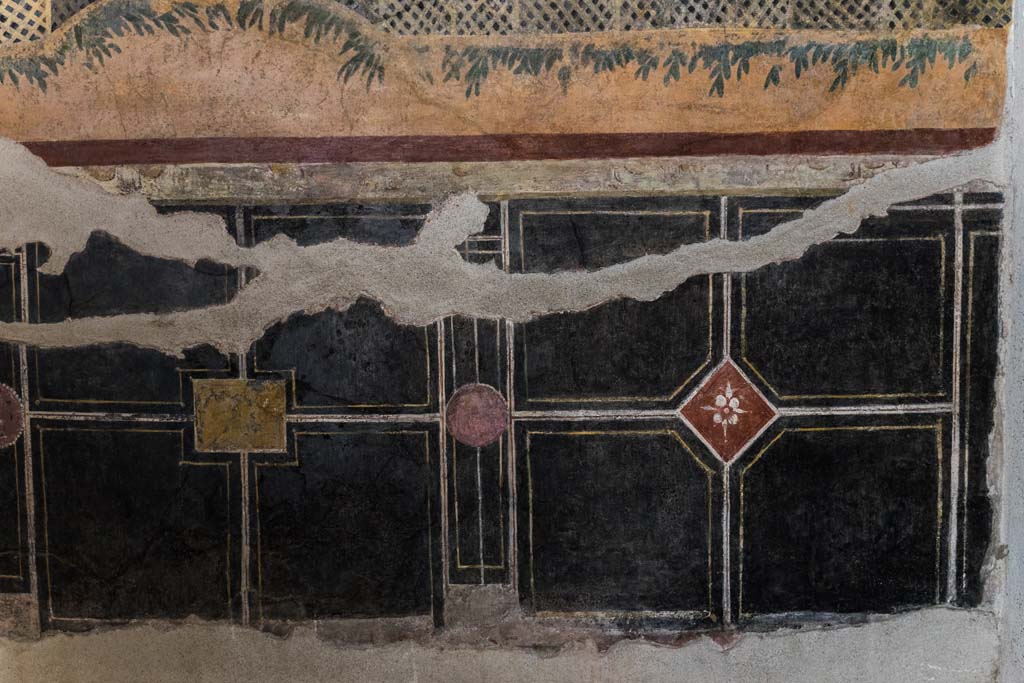 I.9.5 Pompeii. April 2022. 
Room 11, looking towards zoccolo on lower east wall of cubiculum. Photo courtesy of Johannes Eber.
