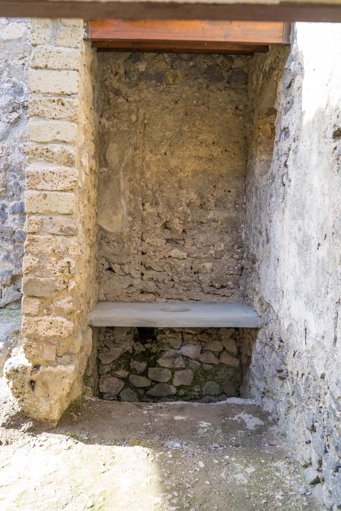 I.9.5 Pompeii. April 2022. 
Room 15, looking towards latrine in kitchen area. Photo courtesy of Johannes Eber.