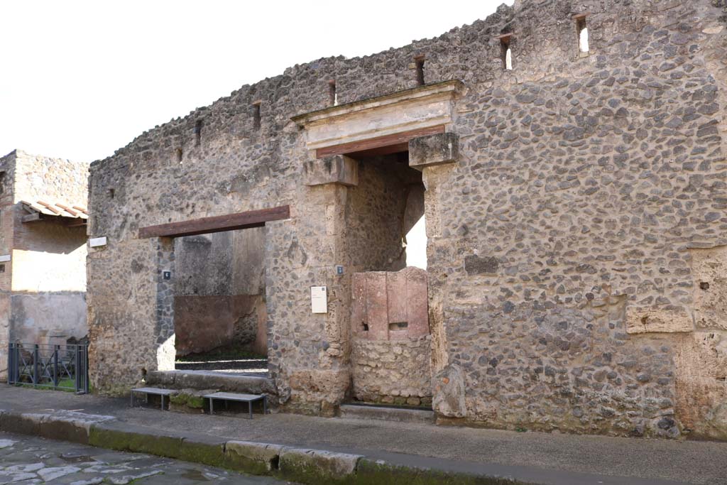 I.9.6 Pompeii. December 2018. 
Entrance doorway on left next to small roadway. Entrance doorway to I.9.5 with plaster cast of doors, in centre.
Photo courtesy of Aude Durand.