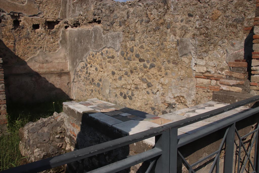 I.9.11 Pompeii. October 2022. 
Looking north-east across counter in bar-room, from entrance doorway. Photo courtesy of Klaus Heese.