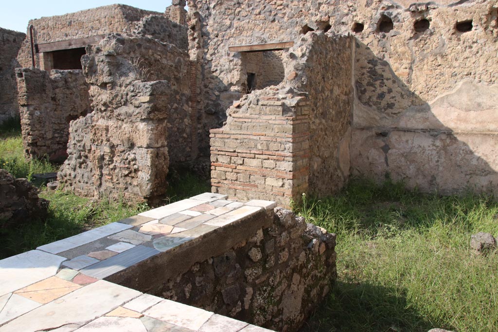 I.9.11 Pompeii. October 2022. Looking north-west towards I.9.12, across top of counter. Photo courtesy of Klaus Heese.