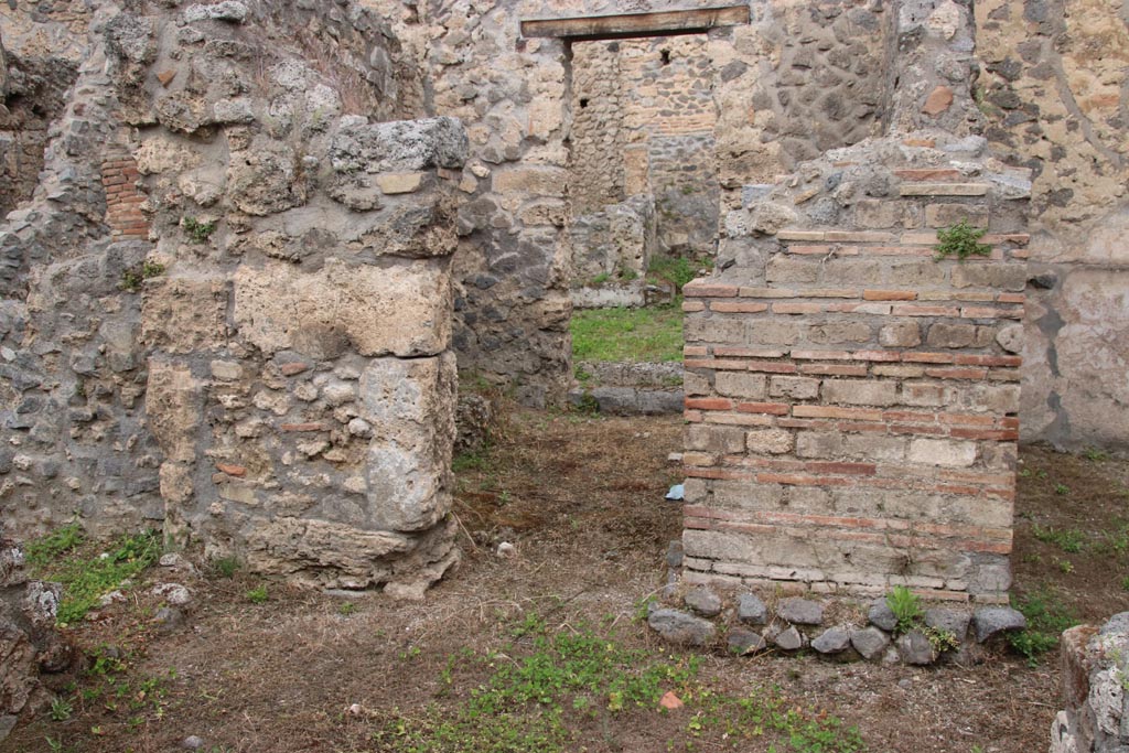 I.9.11 Pompeii. May 2024. 
Looking north to doorway to rear room on west side, and doorway to rear yard. Photo courtesy of Klaus Heese.