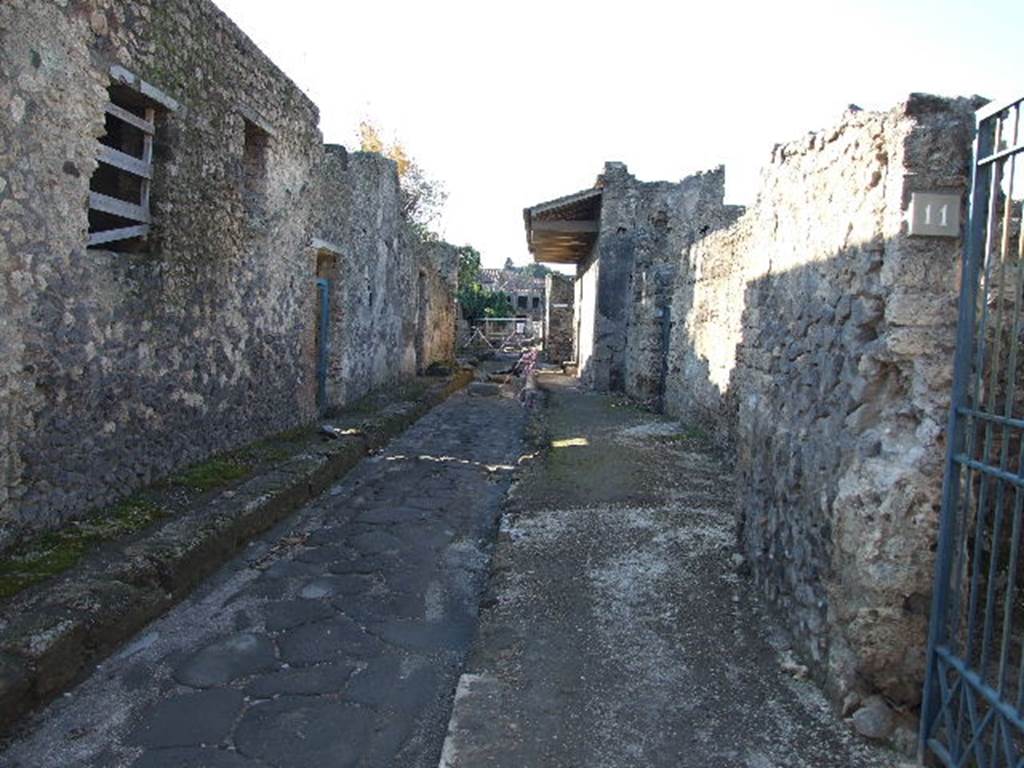 I.17          Via di Castricio looking west.    December 2006.         I.9.11 front wall.