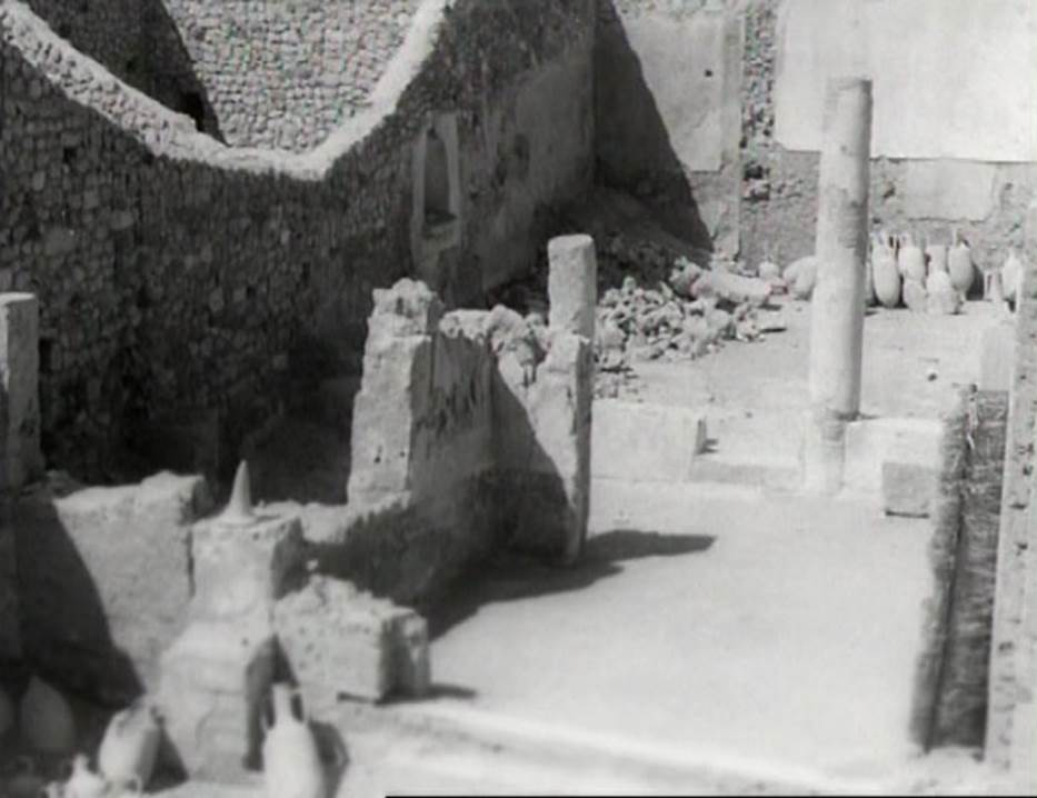 I.9.12 Pompeii. Photo taken in 1954, shortly after excavation. 
Looking north through tablinum towards garden area/peristyle. Note the lararium niche on the west wall.