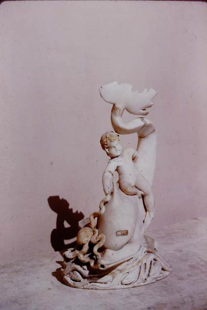 I.9.14 Pompeii. 1966. Marble amorino on dolphin with octopus.  Photo by Stanley A. Jashemski.
Source: The Wilhelmina and Stanley A. Jashemski archive in the University of Maryland Library, Special Collections (See collection page) and made available under the Creative Commons Attribution-Non Commercial License v.4. See Licence and use details.
J66f0740