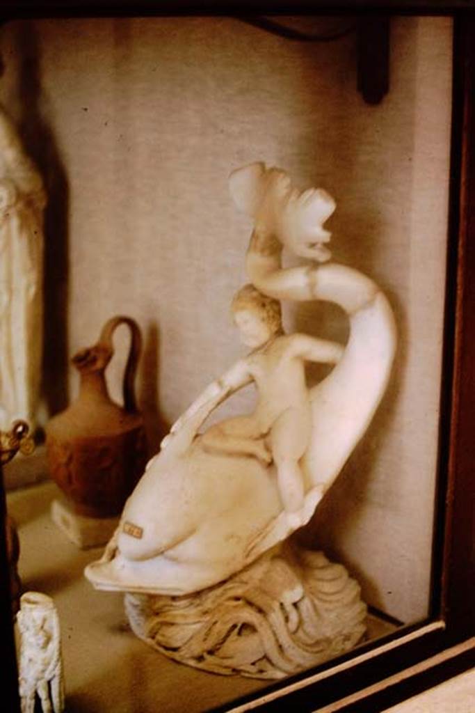 I.9.14 Pompeii. 1964.  Marble fountain statuette. Amorino on dolphin with octopus.  Photo by Stanley A. Jashemski.
Source: The Wilhelmina and Stanley A. Jashemski archive in the University of Maryland Library, Special Collections (See collection page) and made available under the Creative Commons Attribution-Non Commercial License v.4. See Licence and use details.
J64f2052