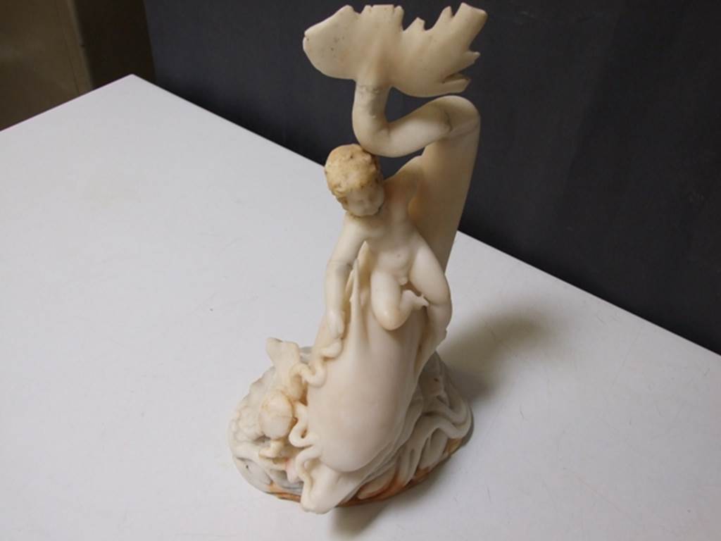 I.9.14 Pompeii.  Marble fountain statuette.  Amorino on dolphin with octopus.  SAP inventory number 8126.  Found in 1951.
