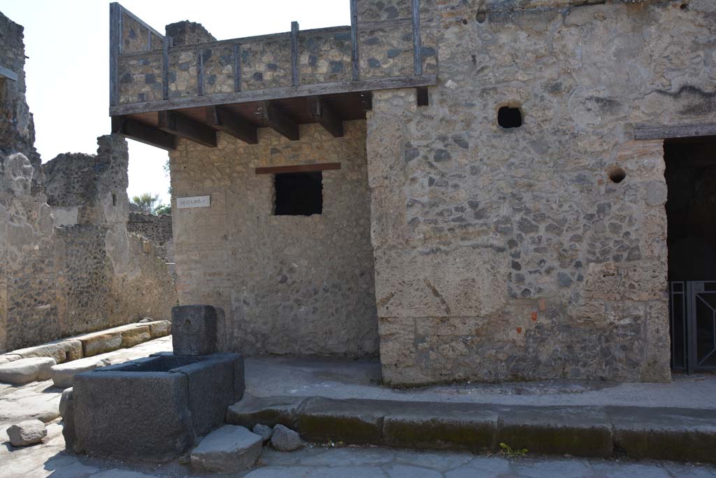 I.10.1 Pompeii, on right. April 2017. 
Looking south in Vicolo del Menandro, towards fountain at junction with Vicolo di Paquius Proculus (on left).
Photo courtesy Adrian Hielscher.