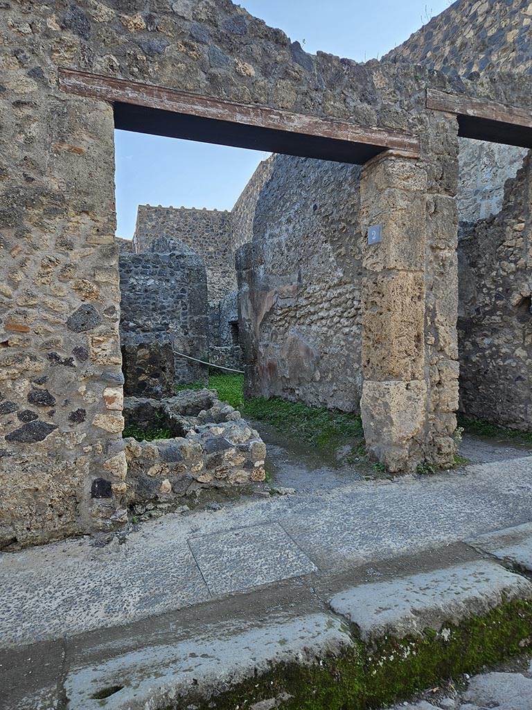 I.10.2, Pompeii. November 2024.
Looking towards entrance on south side of Vicolo del Menandro. Photo courtesy of Annette Haug.