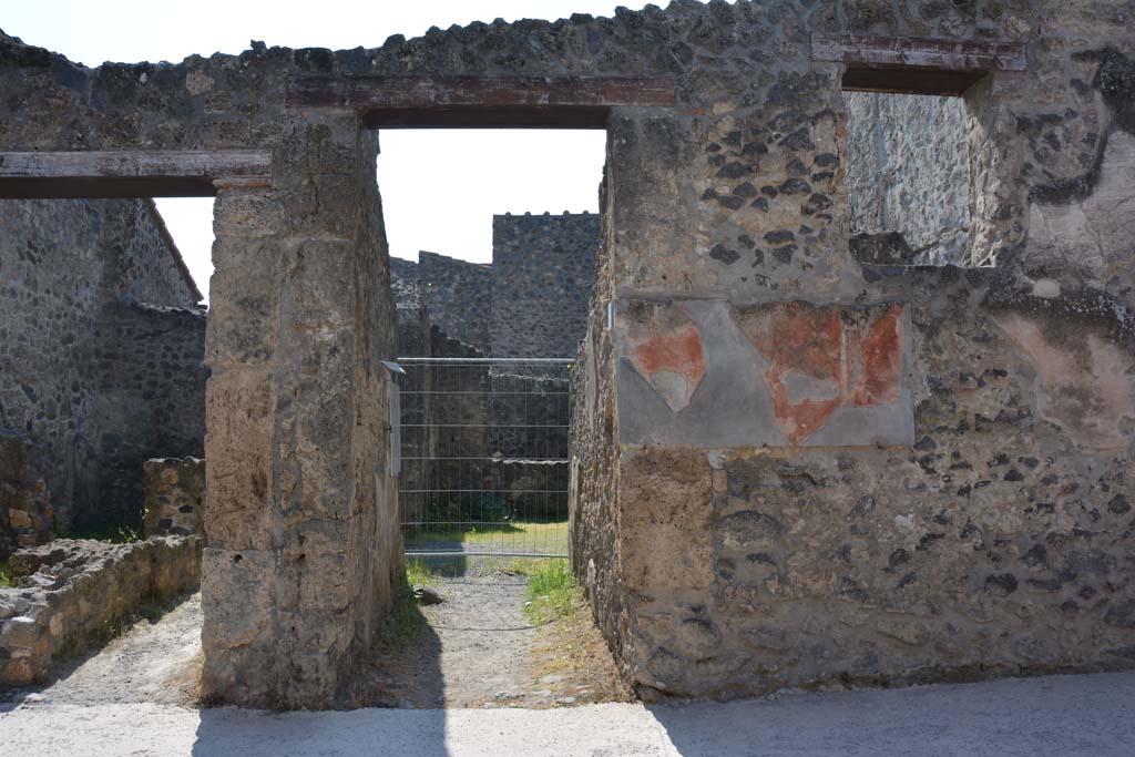 I.10.2 (on left) and I.10.3 Pompeii, (in centre). April 2017. Looking south on Vicolo del Menandro towards entrances. 
Photo courtesy Adrian Hielscher.