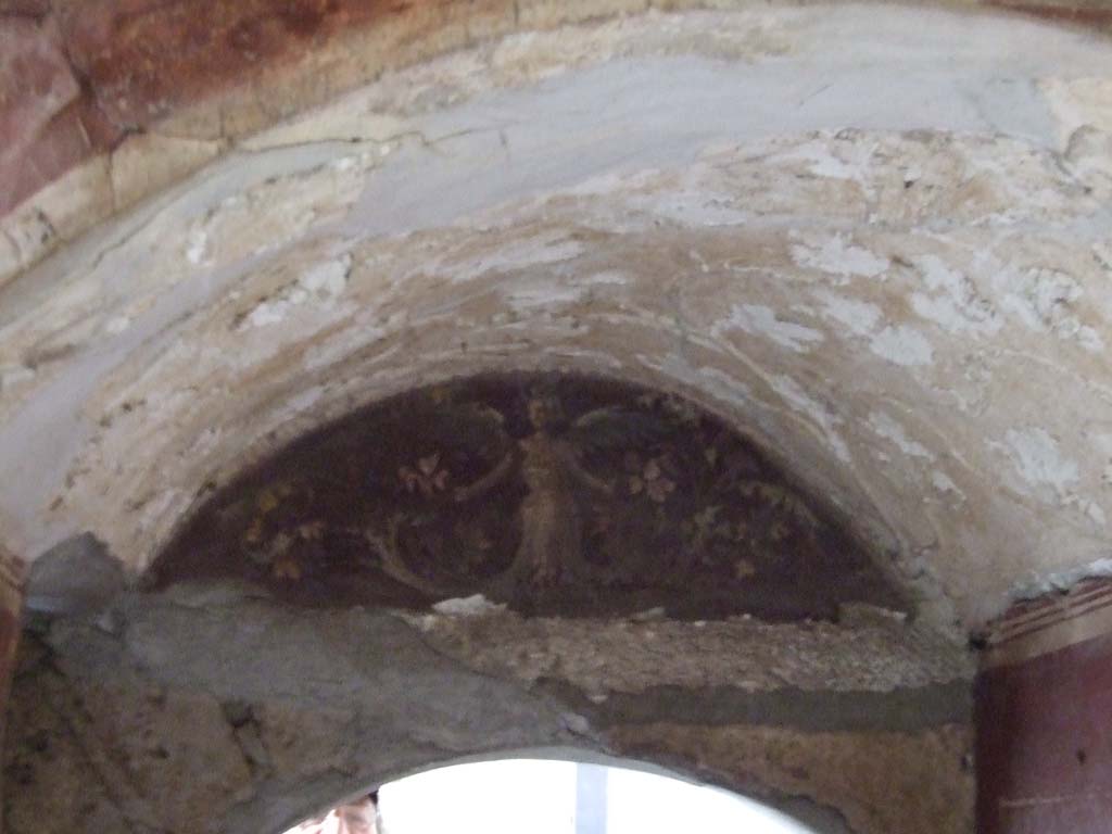 I.10.4 Pompeii. December 2006. Room 48, arched wall above doorway to room 47. 
Wall with painting of female winged figure and plants or vines.
See Bragantini, de Vos, Badoni, 1981. Pitture e Pavimenti di Pompei, Parte 1. Rome: ICCD. (p.131).