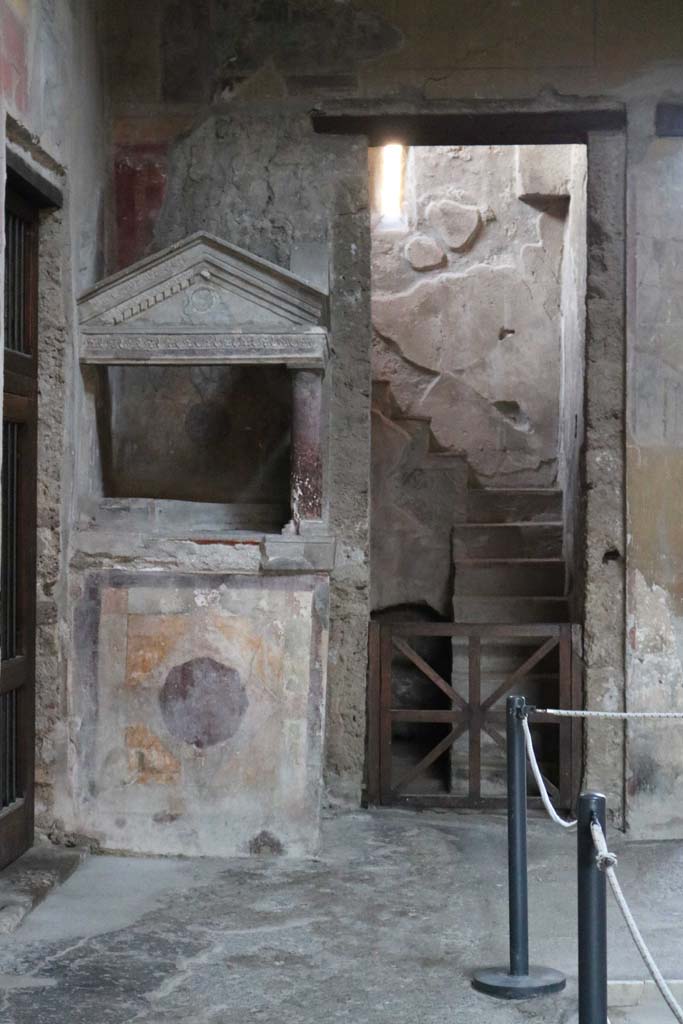 I.10.4 Pompeii. December 2018.  
Looking towards north-west corner of atrium, the lararium and doorway to room 2. 
Photo courtesy of Aude Durand.