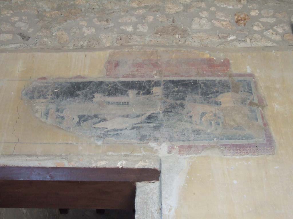 I.10.4 Pompeii. May 2006.  
Atrium, north wall in upper north-east corner, above doorway to room 1. Detail of painted panel with architectural scene.