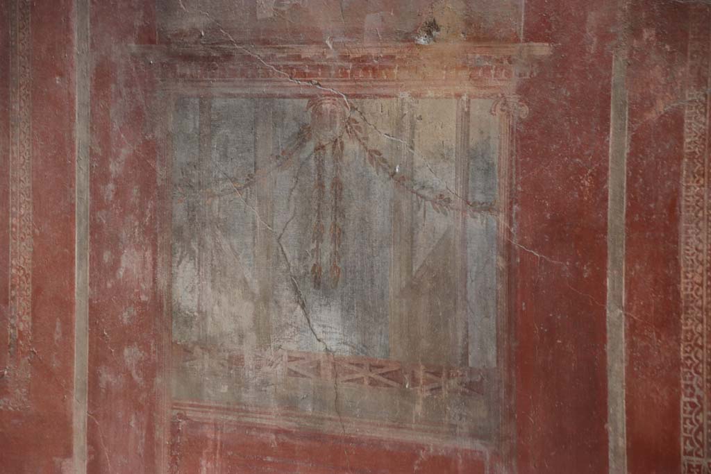 I.10.4 Pompeii. September 2021. 
Room 4, detail of painted decoration from south wall below the centre painting. Photo courtesy of Klaus Heese.