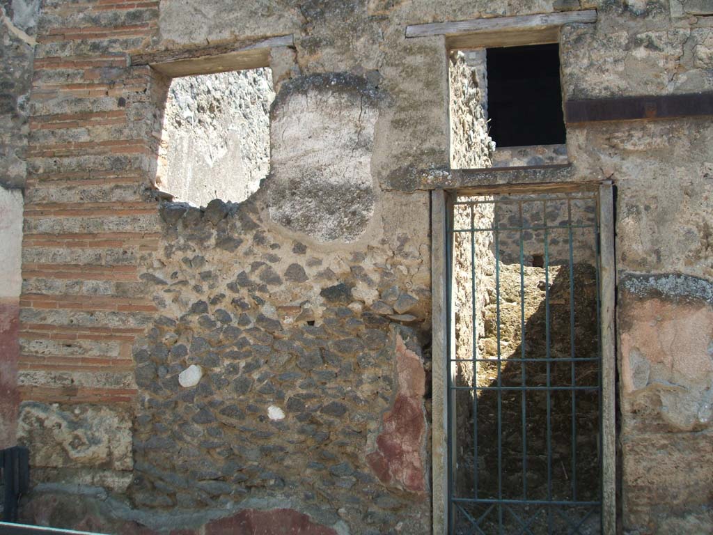I.10.5 Pompeii. May 2005. Exterior wall on east (left) side of doorway to steps to upper floor.