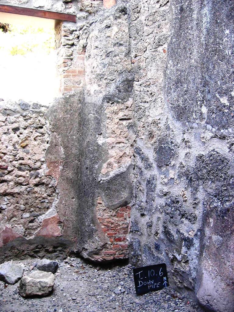I.10.6 Pompeii. July 2008. 
Looking towards north-east corner, with downpipe from upper room. Photo courtesy of Barry Hobson.