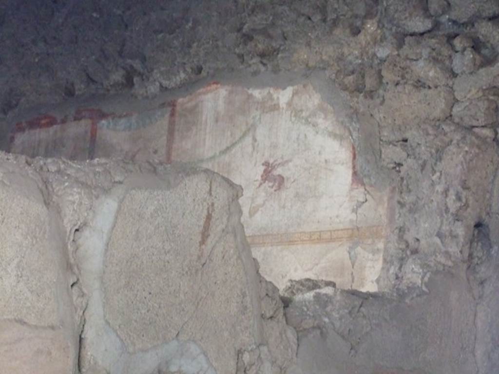 I.10.7 Pompeii. December 2007. Room 2 (taken from south side of room 1). 
Painted plaster with winged beast on west wall.