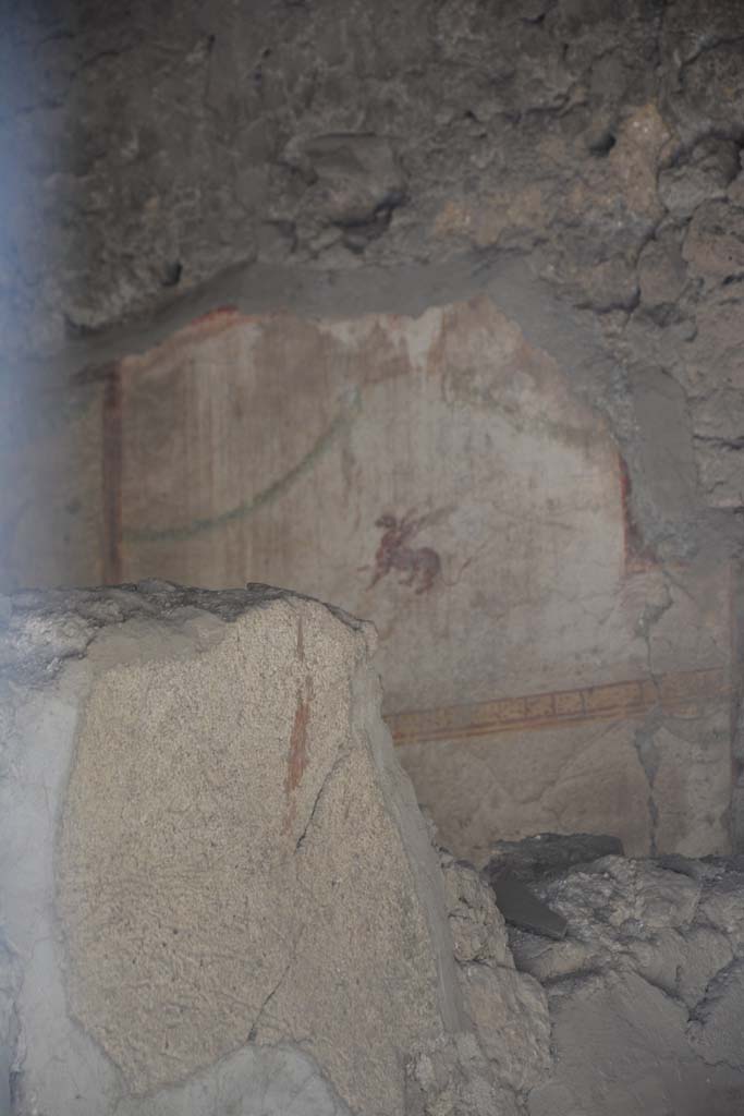 I.10.7 Pompeii. April 2017. Room 2 (taken from entrance doorway). 
Painted plaster with winged beast on west wall. Photo courtesy Adrian Hielscher.