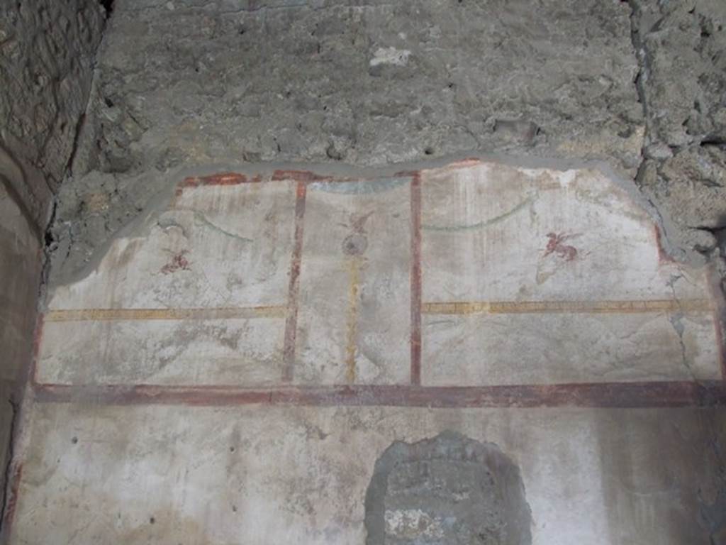 I.10.7 Pompeii. March 2009. Room 2, remains of painted decoration on west wall of cubiculum.