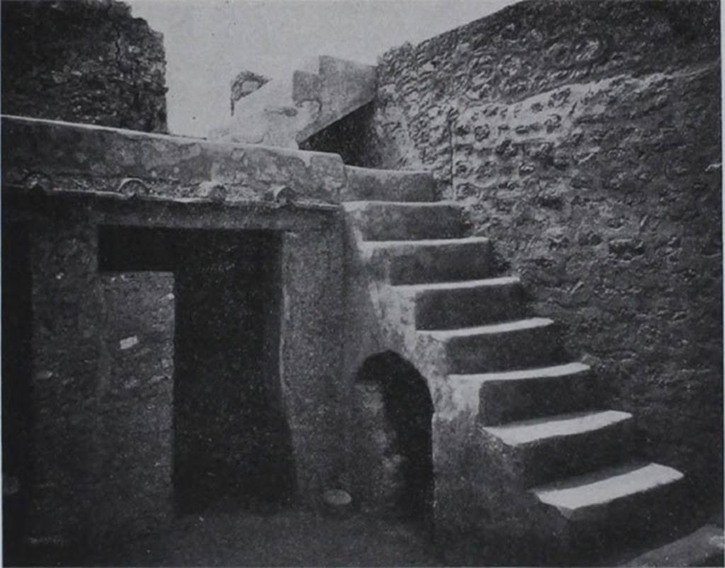 I.10.8 Pompeii. Room 5, south-west corner of the yard, with stairs to upper gallery and cupboard under, and doorway to small room.
These masonry steps against the west wall, were covered with a coating of cocciopesto, and consisted of 9 steps leading to a gallery on which opened a room on the upper floor to the east.  From this then, by another four steps, one arrived at the western rooms of the upper floor.
Al lato occidentale una scalinata di fabbrica, rivestita di intonaco di cocciopesto, di nove gradini che porta ad un ballatoio, sul quale si apre un ambiente del piano superiore ad est.  Da questo poi per altri quattro scalini, si accede al quartierino ovest del piano superiore.
See Notizie degli Scavi di Antichità, 1934, p. 311, fig. 24.