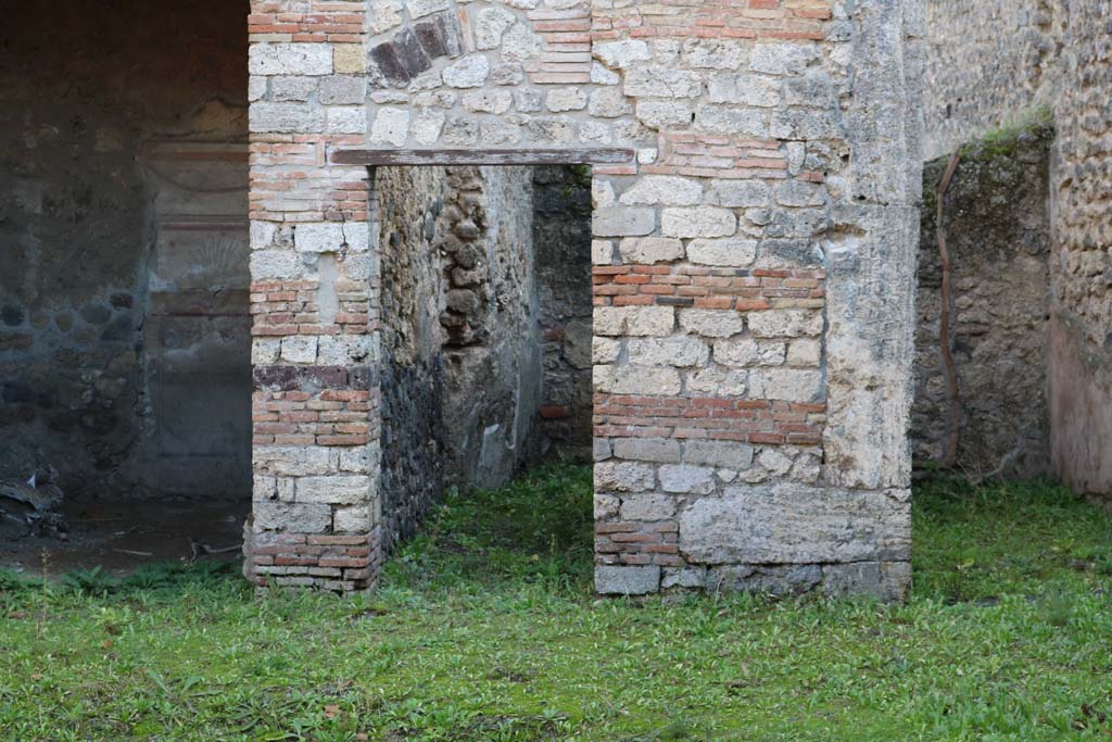 I.10.8 Pompeii. December 2018. 
South side of atrium, with doorways to room 6 on left, room 7 the corridor, and room 8, on right. Photo courtesy of Aude Durand.