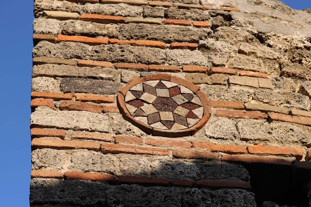 I.10.9 Pompeii. December 2018. Coloured terracotta decorated circular plaque above entrance. Photo courtesy of Aude Durand.