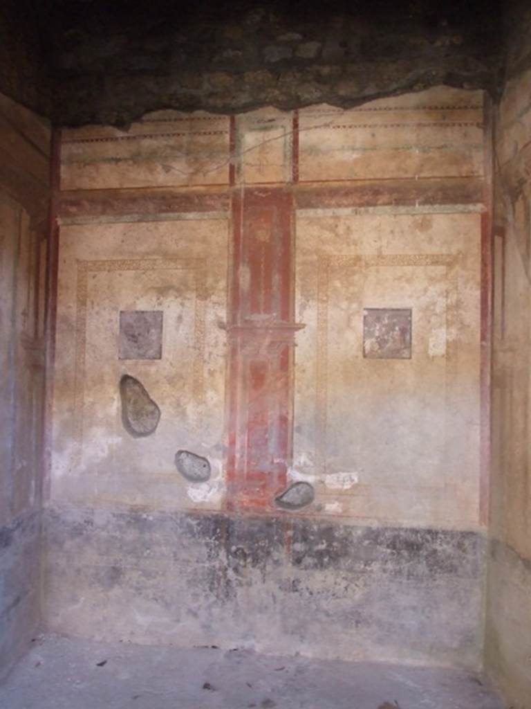 I.10.11 Pompeii. March 2009. Room 6, south wall of ala or exedra.  
According to Peters, two small landscapes were to be seen on the southern wall of the exedra, south of the atrium.
These were in the centres of the side panels. The wall was divided into two parts by a central red compartment.
See Peters, W.J.T. (1963): Landscape in Romano-Campanian Mural Paintings. The Netherlands, Van Gorcum & Comp. (p.151)