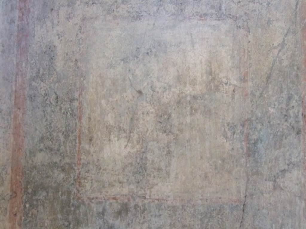 I.10.11 Pompeii. March 2009. Room 8, remains of wall painting from north wall of triclinium.  
According to NdS – 
On the north wall, because of the deterioration suffered to the surface by the peeling plaster and with only a few residual spots of colour, ithe painting was no longer in any way recognizable.
See Notizie degli Scavi, 1934, (p.330).
