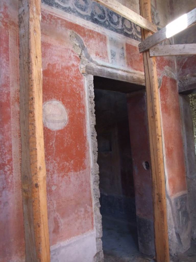 I.10.11 Pompeii. March 2009. Room 2, north-west corner of atrium.    
Doorway to room 9 in west wall, with painted medallion on wall to south.
