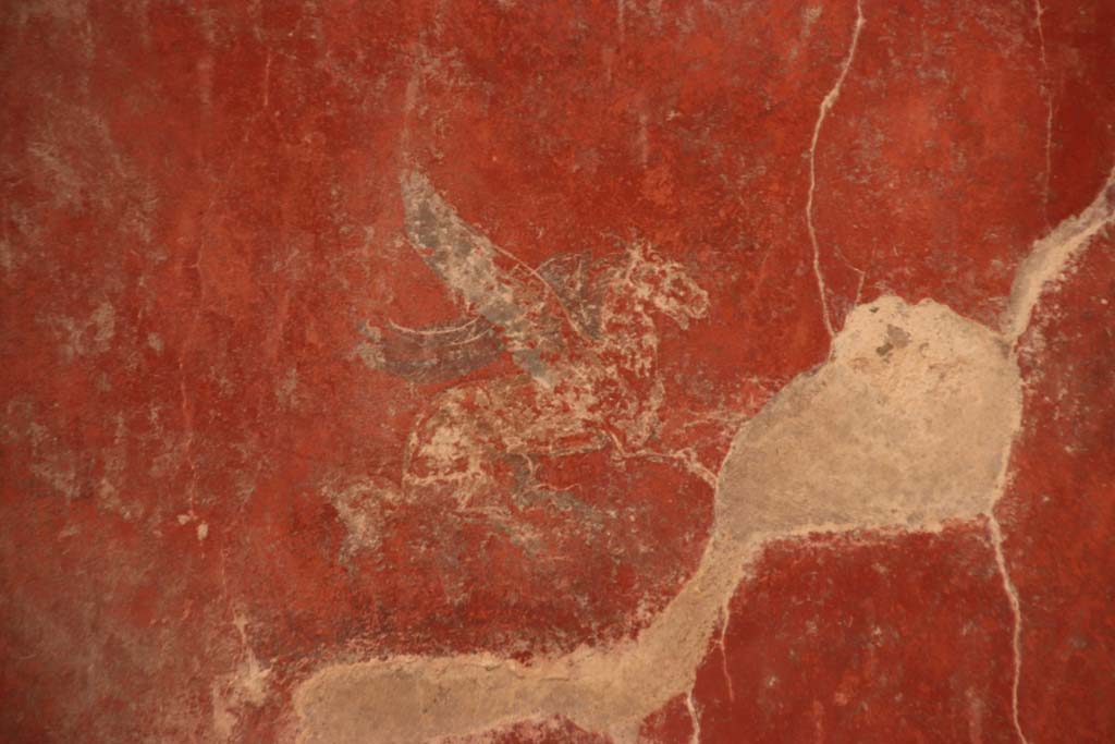 I.10.11 Pompeii. September 2021. 
Room 12, painting of Pegasus from centre of panel at north end of east wall of cubiculum.  Photo courtesy of Klaus Heese.