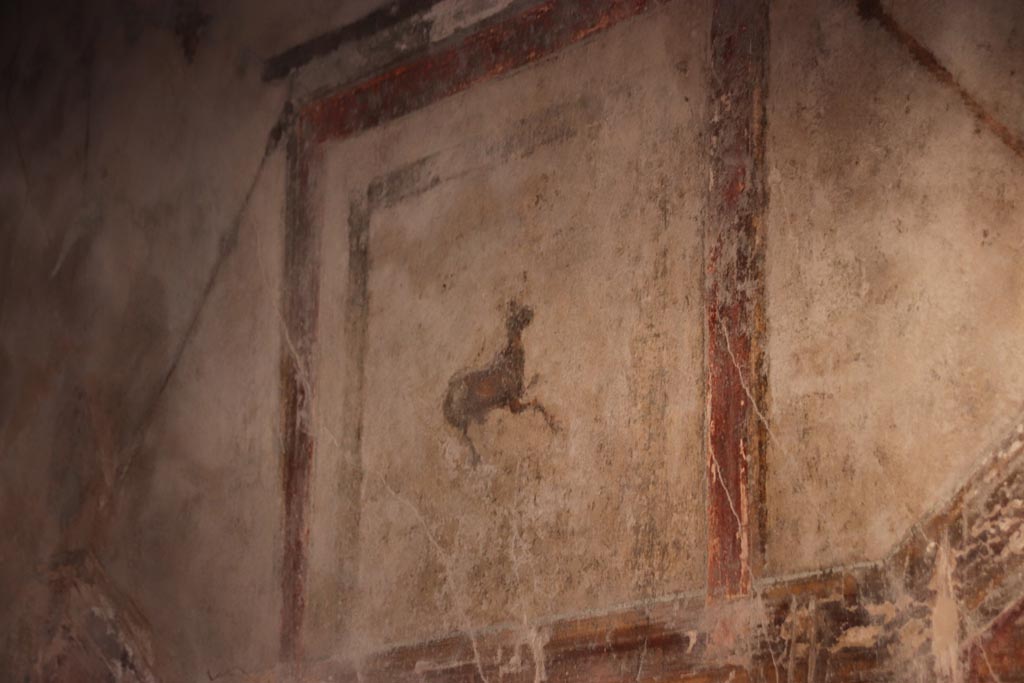 I.10.11 Pompeii. October 2022. Room 12, painting of a goat from upper part of south wall of cubiculum. Photo courtesy of Klaus Heese.