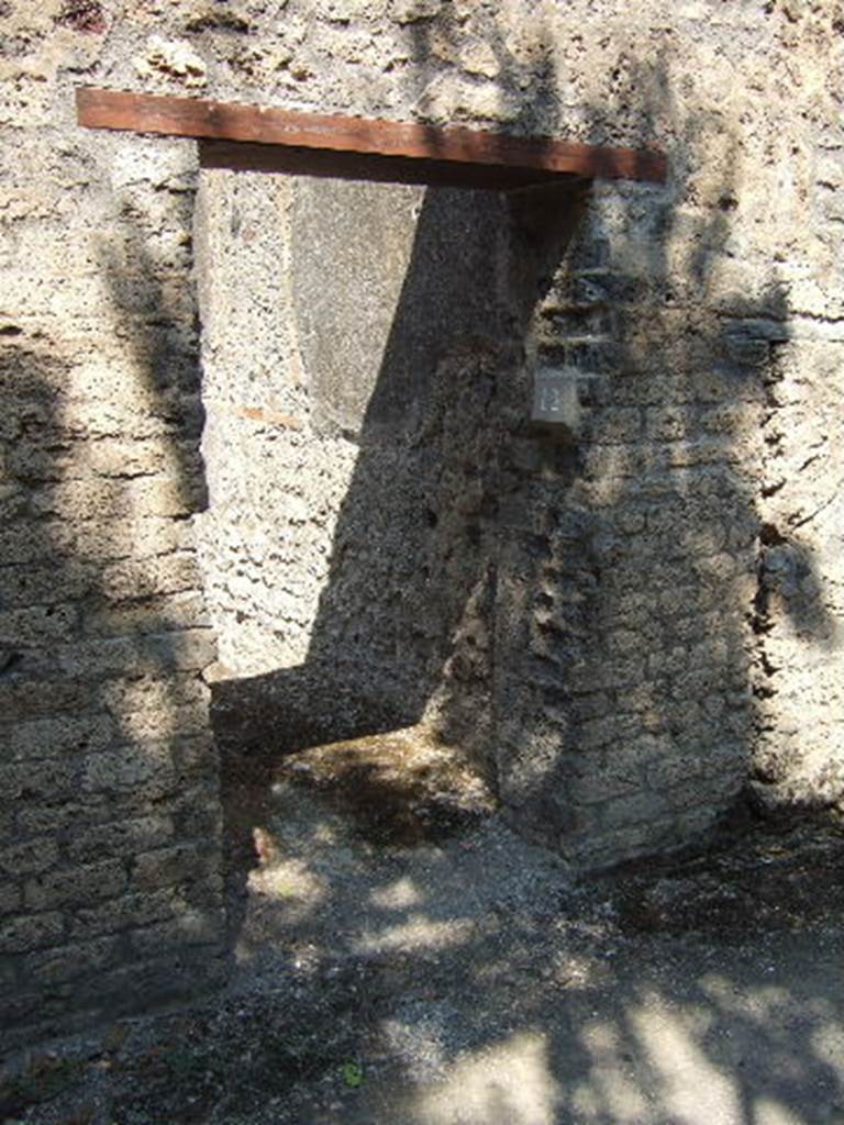 I.10.12 Pompeii. September 2005. Narrow entrance doorway.
According to NdS –
With jambs and sockets of tuff, and with a wooden threshold, access was gained to a spacious room.
This had a cocciopesto floor, walls covered with rough plaster, and a flat ceiling; the door opened to the left of the wall, to increase the lighting of the room, and a rather wide rectangular window was carved into the same south wall.
In the centre of the east wall, was a large breach from the corresponding rustic room of the Casa del Menandro and on the same wall a small doorway of communication, now closed, with the latrine of the same room.
In the west wall, the block of limestone that marked the beginning of the staircase to the upper floor was resting on the ground. 
See Notizie degli Scavi, 1934, (p.340)