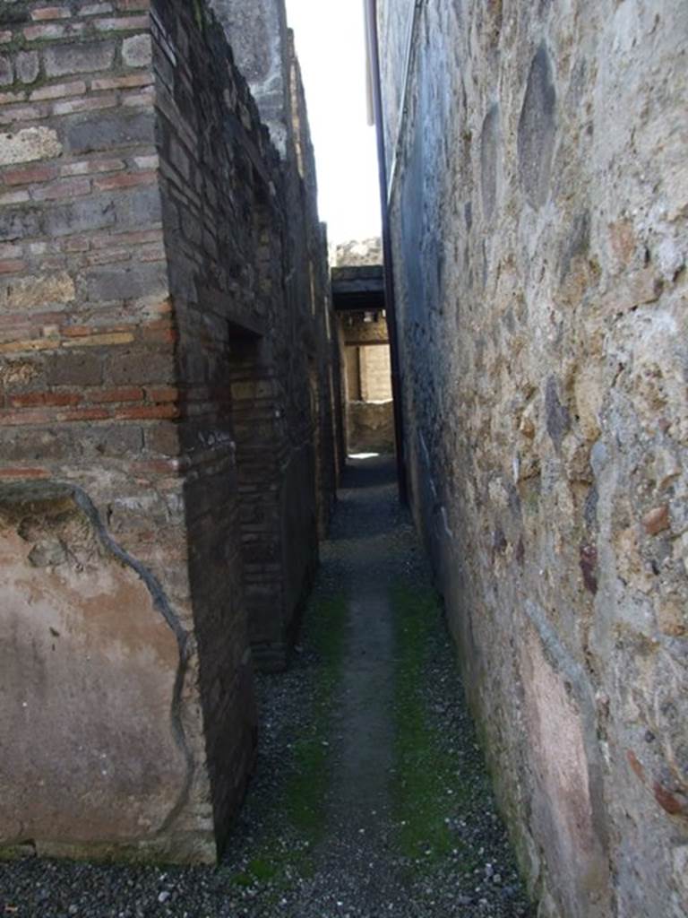 I.10.15 Pompeii.  March 2009.  Room on north side of entrance.  Corridor looking south past rooms to I.10.4.