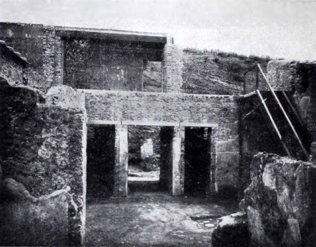 I.10.18 Pompeii. Looking east across atrium towards entrance doorway, in centre, between doorways to rooms 2 & 3.
On the right, is a reconstructed staircase on the south side of the atrium, leading up to the rooms of the upper floor.
See Notizie degli Scavi di Antichità, 1934, p. 342, fig.37.
