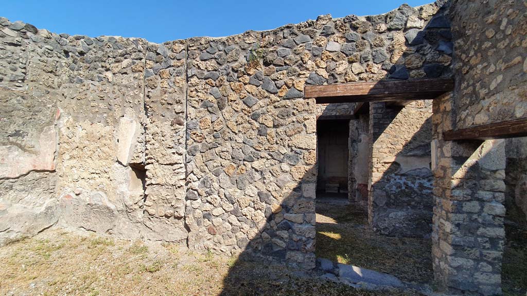 I.11.1 Pompeii. July 2021. 
Looking north from room on south side of bar-room, looking towards doorway to cubiculum and ala, centre right. 
The doorway on the right led into the room with the benches and lararium.
Foto Annette Haug, ERC Grant 681269 DÉCOR.