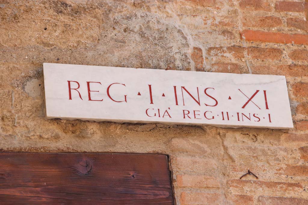 I.11.1 Pompeii. September 2019. Insula identification plaque, Reg. I. Ins. X1, previously known as Reg. II, Ins. 1.
Photo courtesy of Klaus Heese.